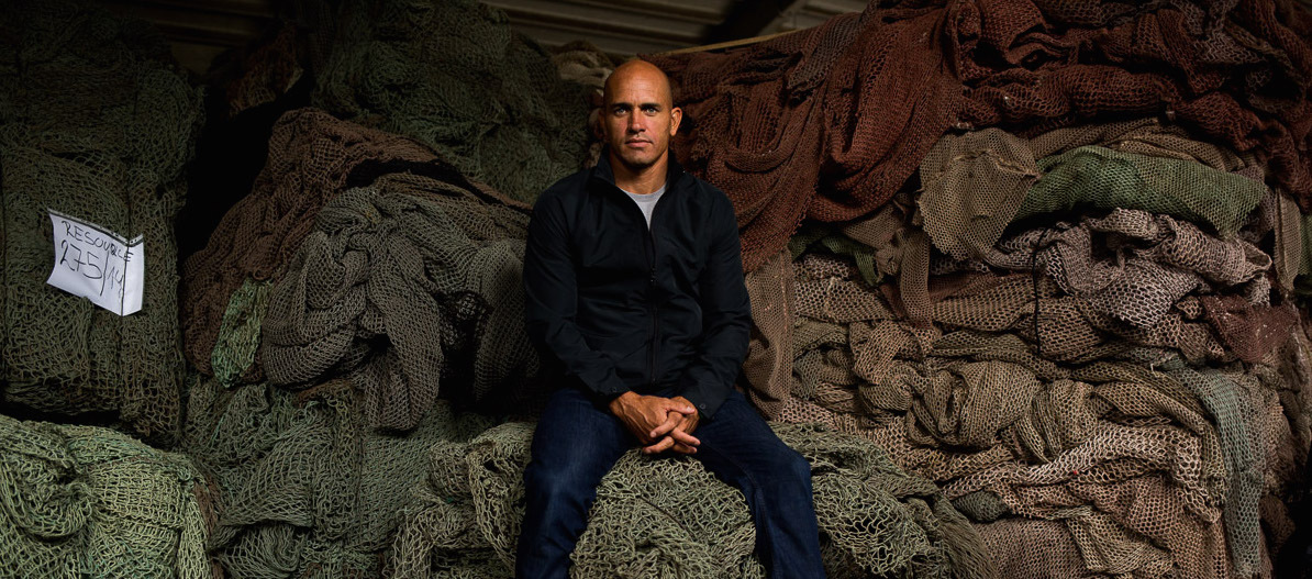 Kelly Slater sits with fishing nets like those collected for Outerknown at the ECONYL manufacturing plant (Photo: Business Wire).  