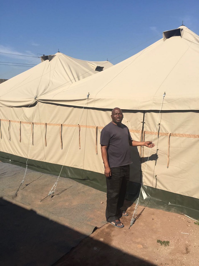 Pastor Ndlovu standing next to the Dassenhoek community clinic and social/education centre. © Gelvenor