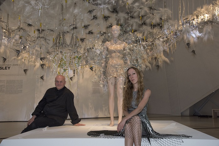 Iris van Herpen and Phillip Beesley with the Dome dress at the ROM seen against a backdrop of Beesley’s interactive Aegis canopy that uses a curiosity algorithm to constantly change and search for new patterns of behaviour. © ROM