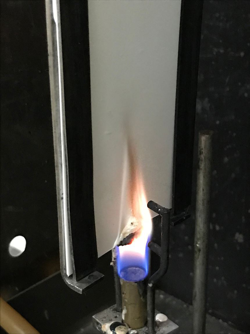 PAL...VersaCHAR in a vertical 60 second vertical burn test at 1,950Â°C, with black char-bodies forming at the bottom of the nonwoven wallcovering substrate.