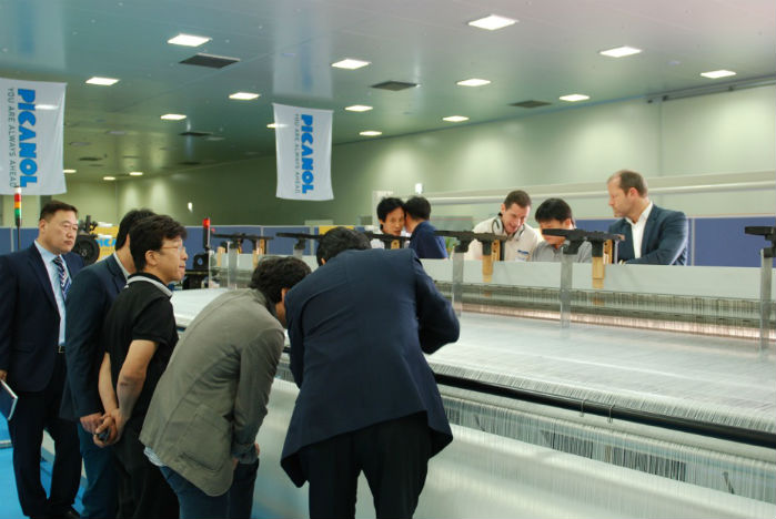 The company has been presenting two versions of its OptiMax rapier weaving machine with the OptiMax 540 cm being showcased for the first time in Korea. © Picanol