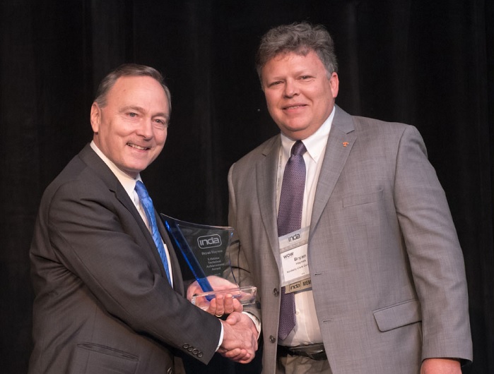 INDA President Dave Rousse presented the award at the association’s annual World of Wipes International Conference. © INDA