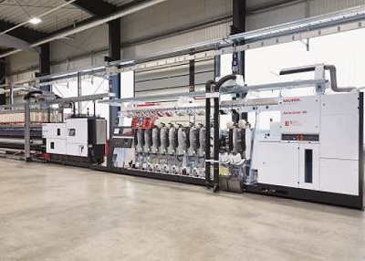 The machine represents a future-orientated direct link to the ring-spinning process with the integrated online quality monitoring system SPID. © Saurer Group